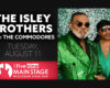 Promo poster for The Isley Brothers with The Commodores at Wisconsin State Fair; left shows bold event text, right features two men in green sequined outfits.